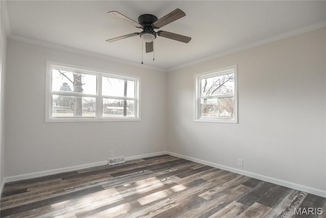 514 W Missouri St, Bloomfield, MO 63825 - spare room with dark wood-type flooring, healthy amount of natural light, baseboards, and ornamental molding