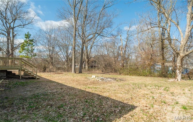 514 W Missouri St, Bloomfield, MO 63825 - view of grassy yard with stairs and a wooden deck