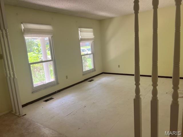 1211 Dorne Dr, Manchester, MO 63021 - empty room with a textured ceiling and baseboards
