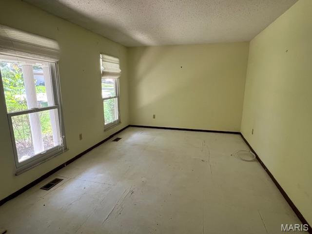 1211 Dorne Dr, Manchester, MO 63021 - unfurnished room with a textured ceiling and baseboards