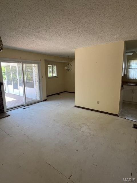 1211 Dorne Dr, Manchester, MO 63021 - empty room with a textured ceiling and a chandelier