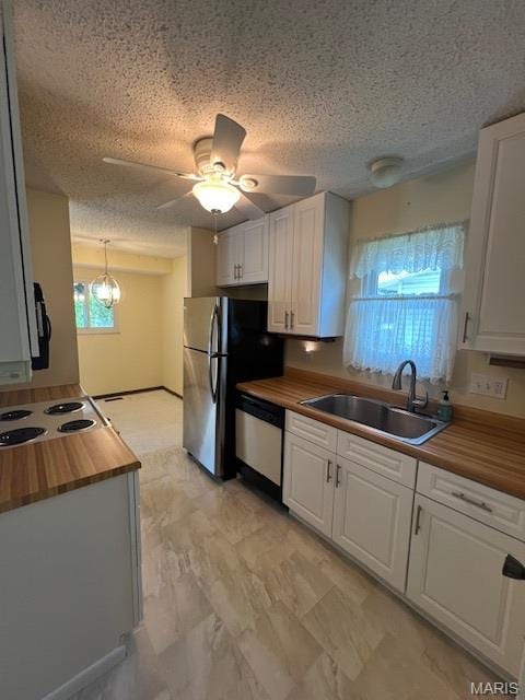 1211 Dorne Dr, Manchester, MO 63021 - kitchen featuring butcher block countertops, dishwashing machine, white cabinetry, a ceiling fan, and a textured ceiling