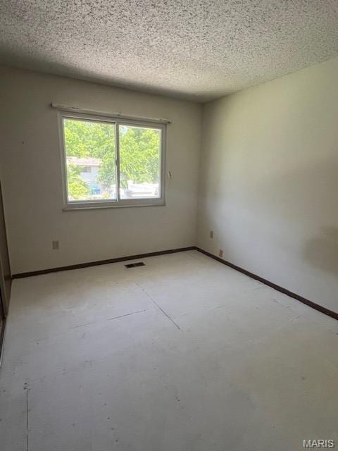 1211 Dorne Dr, Manchester, MO 63021 - unfurnished room with unfinished concrete floors and a textured ceiling