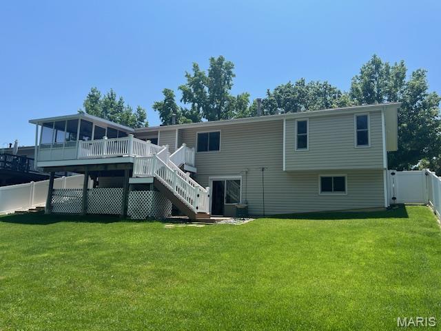 1211 Dorne Dr, Manchester, MO 63021 - back of house featuring stairs, a deck, and a fenced backyard
