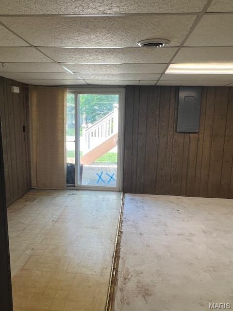1211 Dorne Dr, Manchester, MO 63021 - basement featuring electric panel, wood walls, and a paneled ceiling
