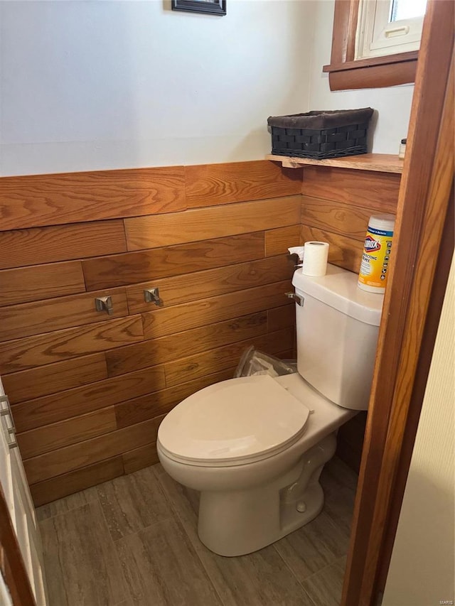 bathroom featuring wood finished floors and toilet