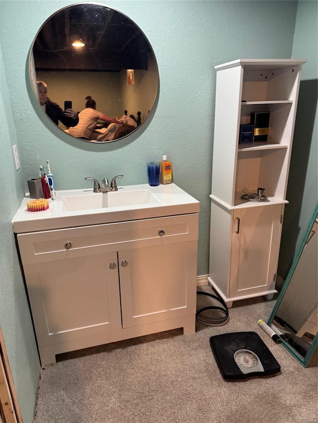 bathroom featuring a textured wall and vanity