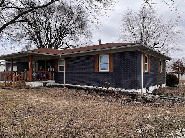 view of front of property with a porch and brick siding