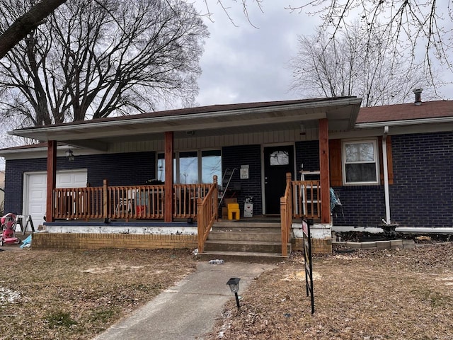 ranch-style house featuring brick siding, a porch, and a garage