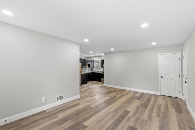 1686 Mowbry Ln, Saint Louis, MO 63136 - unfurnished living room featuring light wood finished floors, recessed lighting, and baseboards