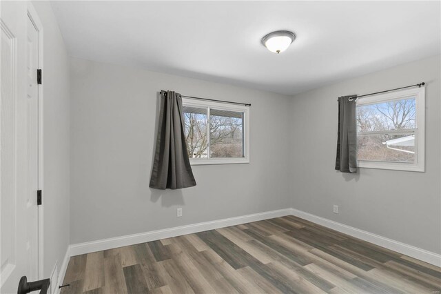 1686 Mowbry Ln, Saint Louis, MO 63136 - empty room with plenty of natural light, wood finished floors, and baseboards