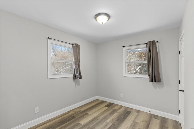 1686 Mowbry Ln, Saint Louis, MO 63136 - unfurnished room with plenty of natural light, baseboards, and wood finished floors