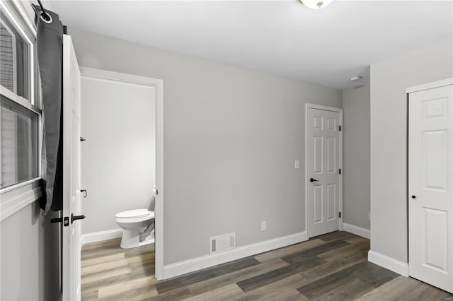1686 Mowbry Ln, Saint Louis, MO 63136 - unfurnished bedroom featuring wood finished floors, baseboards, ensuite bath, and a closet
