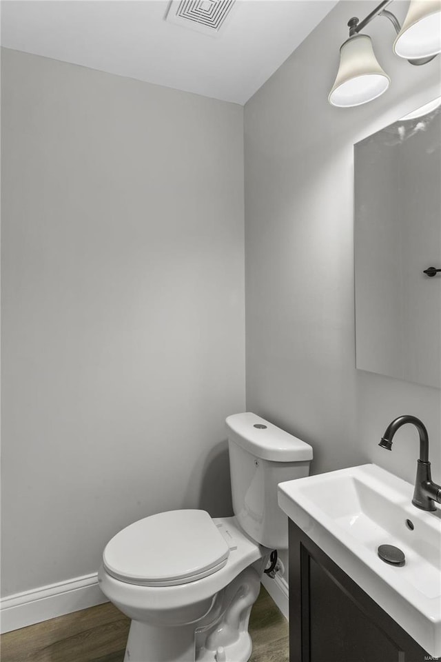 1686 Mowbry Ln, Saint Louis, MO 63136 - bathroom featuring toilet, wood finished floors, vanity, and baseboards