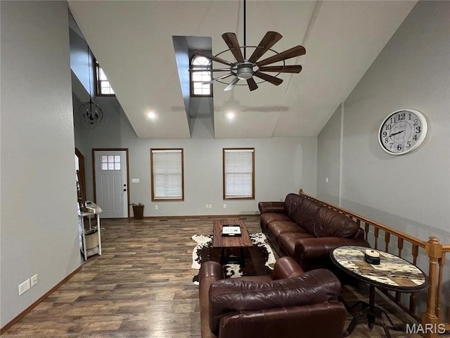 living room with a ceiling fan, wood finished floors, high vaulted ceiling, and arched walkways
