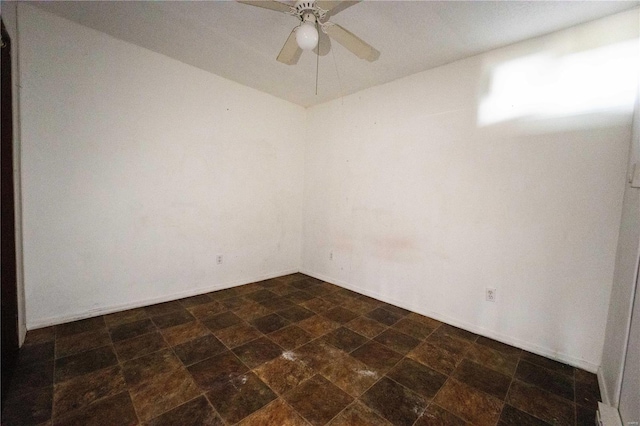1407 N 435th St Unit 1 & 2, Vandalia, IL 62471 - empty room with stone finish floors, a ceiling fan, and baseboards