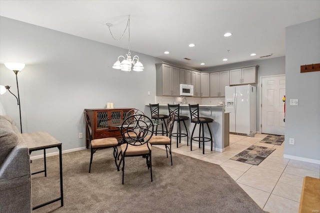 dining room featuring recessed lighting, a chandelier, light tile patterned flooring, and baseboards