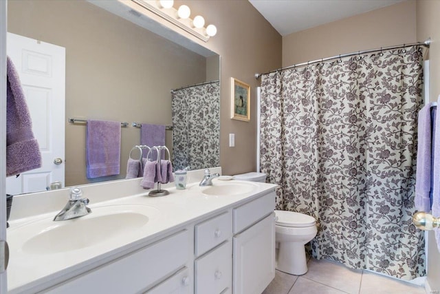 full bath featuring tile patterned floors, toilet, and double vanity