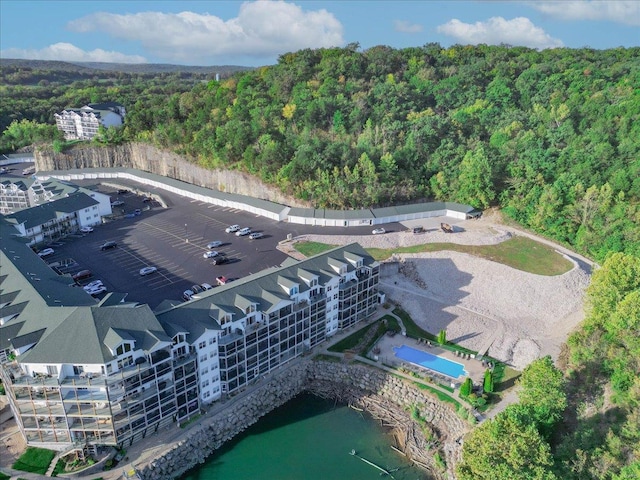aerial view of a heavily wooded area and a pool area