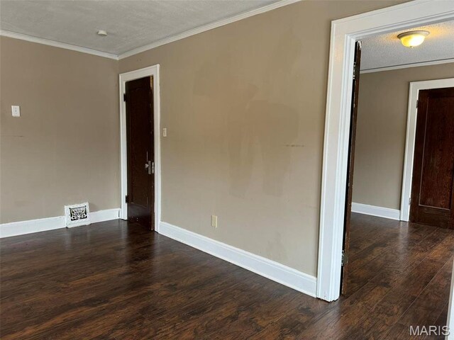 7119 Lexington Ave, Normandy, MO 63121 - empty room featuring dark wood-style floors, ornamental molding, baseboards, and a textured ceiling