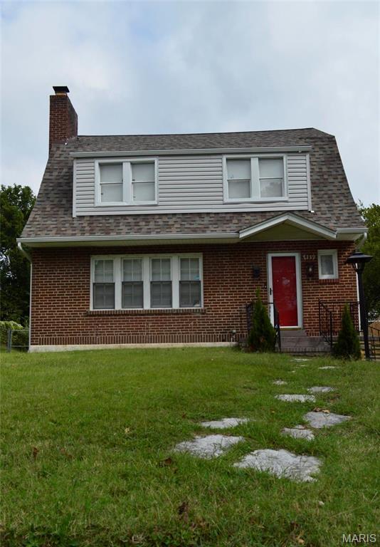 7119 Lexington Ave, Normandy, MO 63121 - view of front of property featuring a chimney, brick siding, and a front lawn