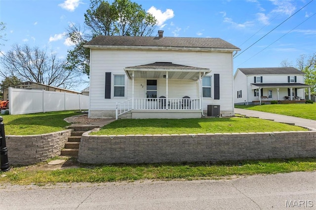 view of front of property with a porch and central AC