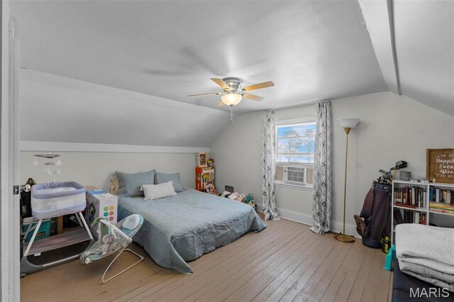 bedroom with lofted ceiling, hardwood / wood-style floors, baseboards, cooling unit, and a ceiling fan