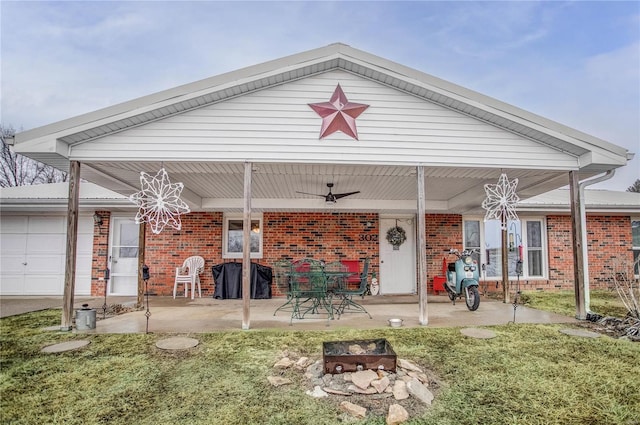 302 E Bay St, Pleasant Hill, IL 62366 - rear view of property with brick siding, ceiling fan, a fire pit, and an attached garage