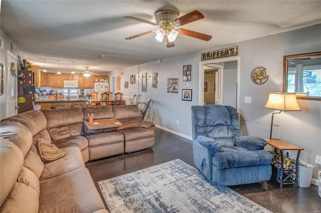 302 E Bay St, Pleasant Hill, IL 62366 - living area with a ceiling fan, a textured ceiling, dark wood-type flooring, and baseboards