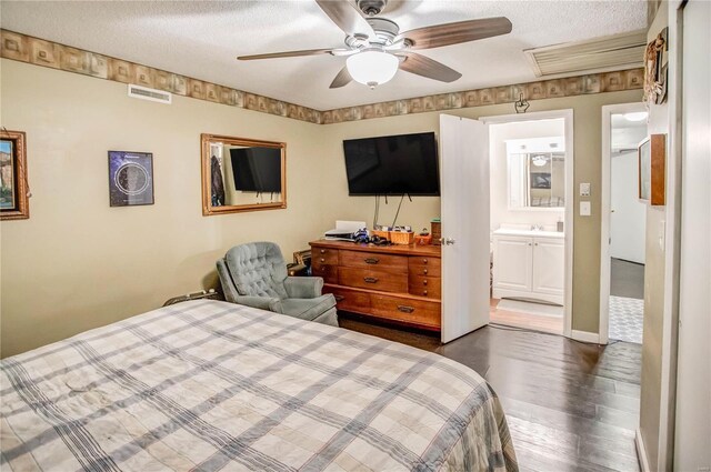 302 E Bay St, Pleasant Hill, IL 62366 - bedroom with wood finished floors, a textured ceiling, a sink, ensuite bathroom, and ceiling fan