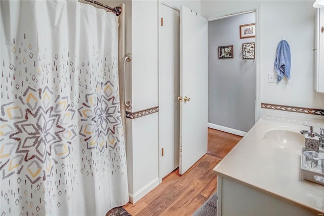 302 E Bay St, Pleasant Hill, IL 62366 - bathroom with wood finished floors, vanity, baseboards, and a shower with curtain