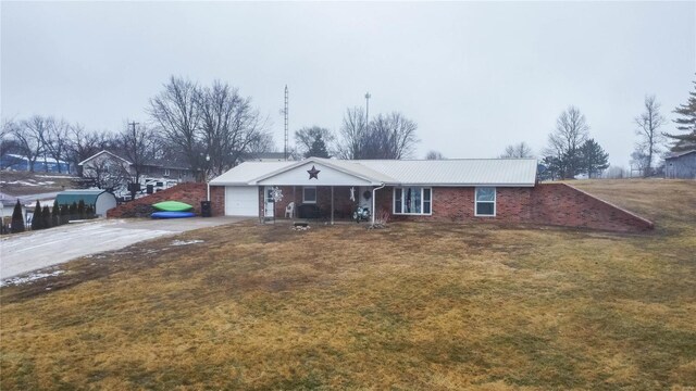 302 E Bay St, Pleasant Hill, IL 62366 - single story home with driveway, a front yard, metal roof, an attached garage, and brick siding