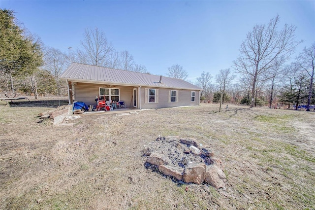 31950 County Road 6250, Edgar Springs, MO 65462 - back of property with a fire pit, metal roof, a ceiling fan, and a patio area