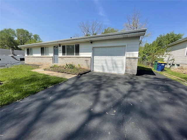 10191 Mayfair Dr, Saint Louis, MO 63136 - view of front of property with a garage, asphalt driveway, and brick siding