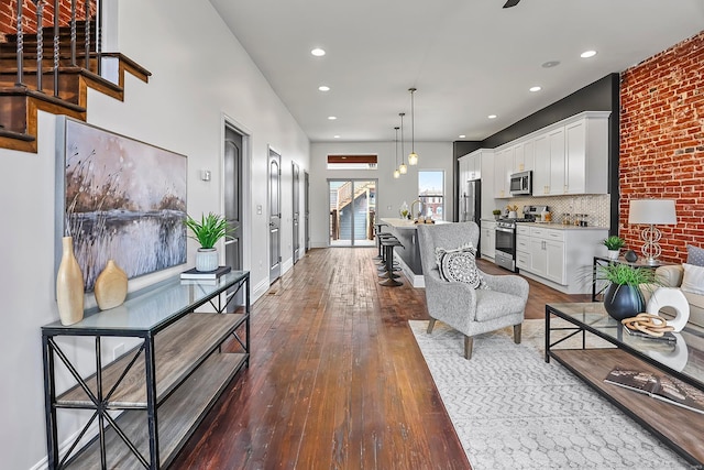 3330 Iowa Ave, Saint Louis, MO 63118 - living room featuring dark wood-style flooring, recessed lighting, stairs, and baseboards