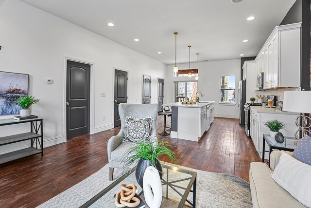 3330 Iowa Ave, Saint Louis, MO 63118 - living area with dark wood-type flooring, recessed lighting, and baseboards