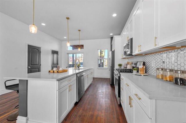 3330 Iowa Ave, Saint Louis, MO 63118 - kitchen featuring appliances with stainless steel finishes, light countertops, a large island, backsplash, and a sink