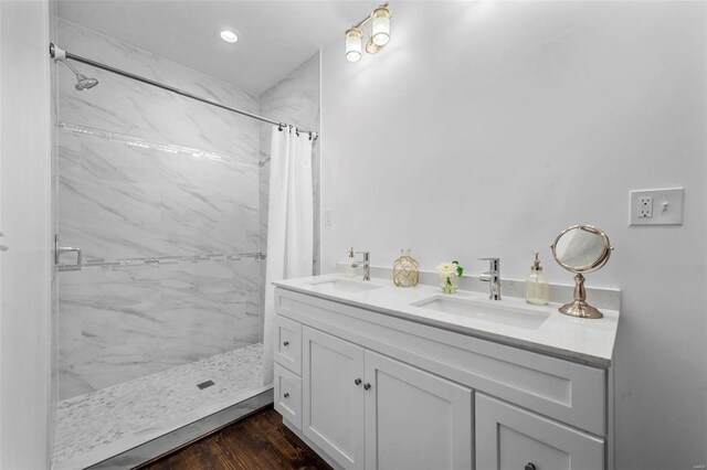 3330 Iowa Ave, Saint Louis, MO 63118 - full bathroom featuring a marble finish shower, recessed lighting, wood finished floors, and double vanity