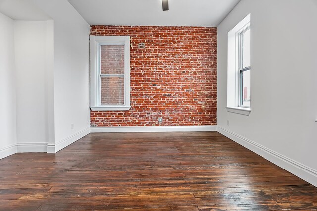 3330 Iowa Ave, Saint Louis, MO 63118 - spare room with brick wall, hardwood / wood-style flooring, baseboards, and ceiling fan