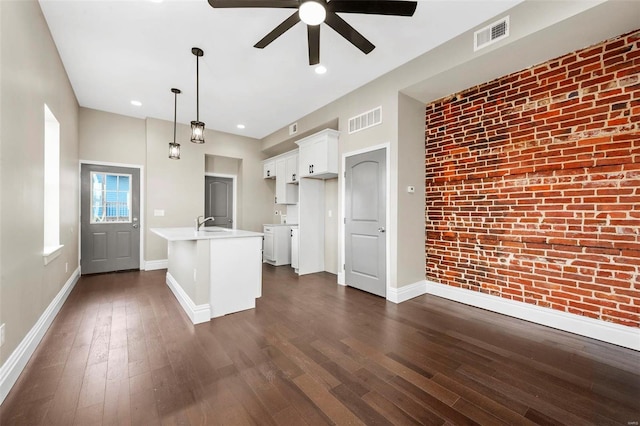 3330 Iowa Ave, Saint Louis, MO 63118 - kitchen with baseboards, ceiling fan, white cabinetry, dark wood-style flooring, and light countertops