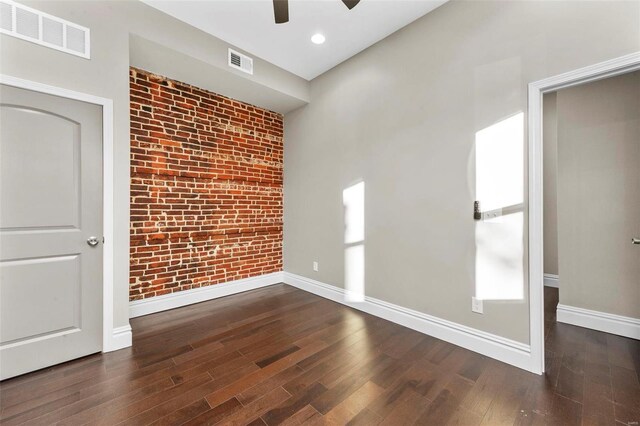3330 Iowa Ave, Saint Louis, MO 63118 - spare room with a ceiling fan, wood finished floors, brick wall, baseboards, and recessed lighting