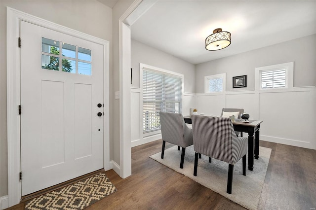 dining area with wood finished floors and an office area