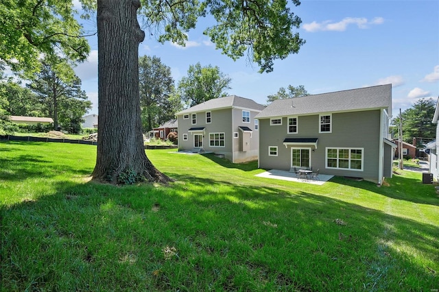 back of property featuring a patio area and a lawn