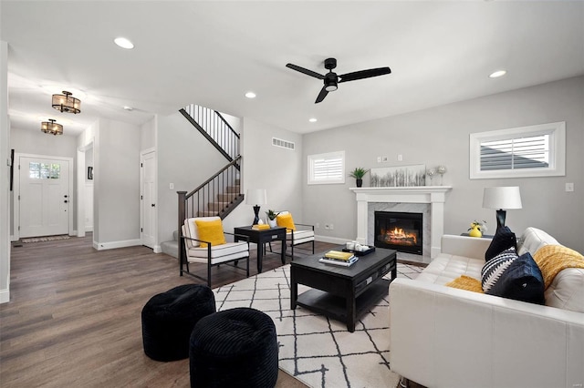 living room featuring plenty of natural light, light wood-style floors, recessed lighting, a ceiling fan, and a fireplace