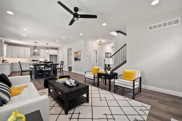 living area featuring a ceiling fan, recessed lighting, wood finished floors, and baseboards