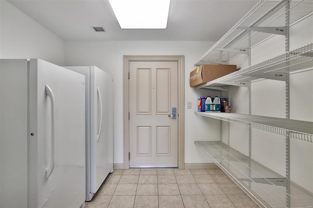 4909 Laclede Ave Unit 1401, Saint Louis, MO 63108 - washroom featuring baseboards and light tile patterned flooring