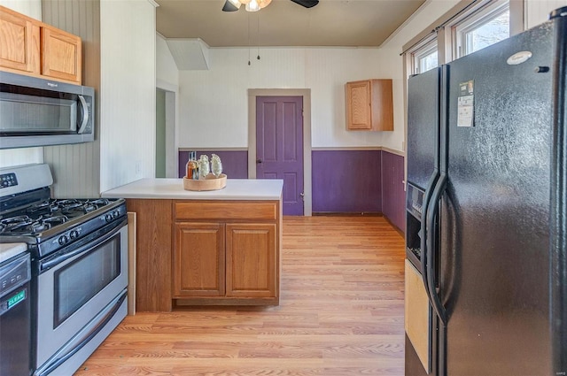 kitchen featuring stainless steel appliances, a peninsula, ceiling fan, light wood-style floors, and light countertops