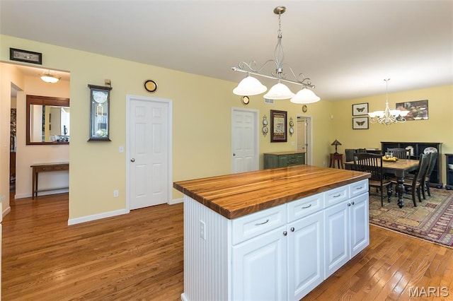 885 Morgan Rdg, High Ridge, MO 63049 - kitchen featuring wooden counters, light wood finished floors, a chandelier, and white cabinets