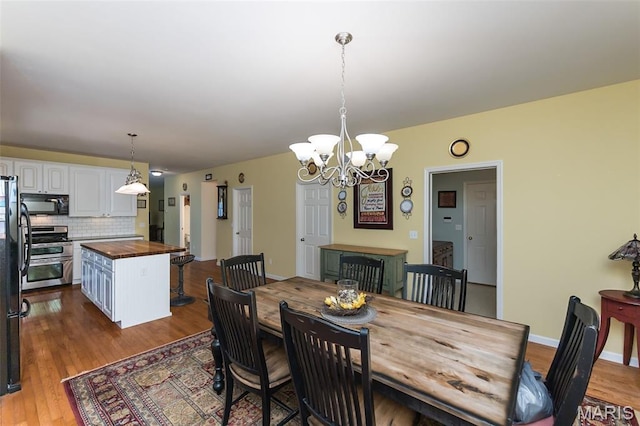 885 Morgan Rdg, High Ridge, MO 63049 - dining area featuring a chandelier and wood finished floors