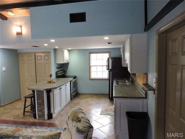 17 Martone St, Elsberry, MO 63343 - kitchen with electric stove, a kitchen bar, white cabinets, a peninsula, and recessed lighting
